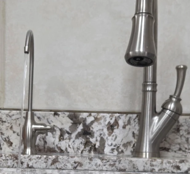 Dedicated reverse-osmosis faucet filling a drinking glass